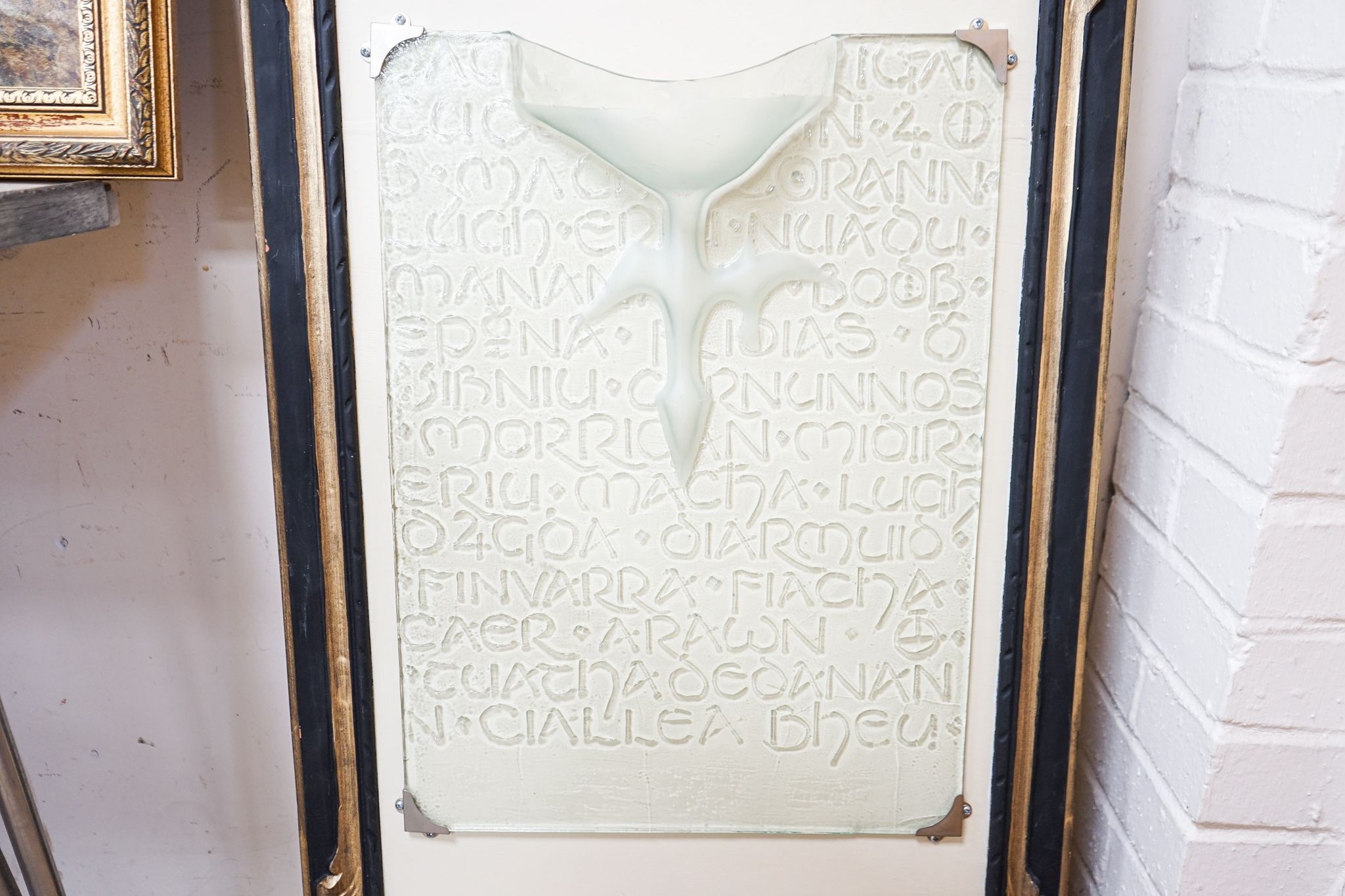 An Irish glass wall fixture moulded with Gaelic script, 56 x 41cm